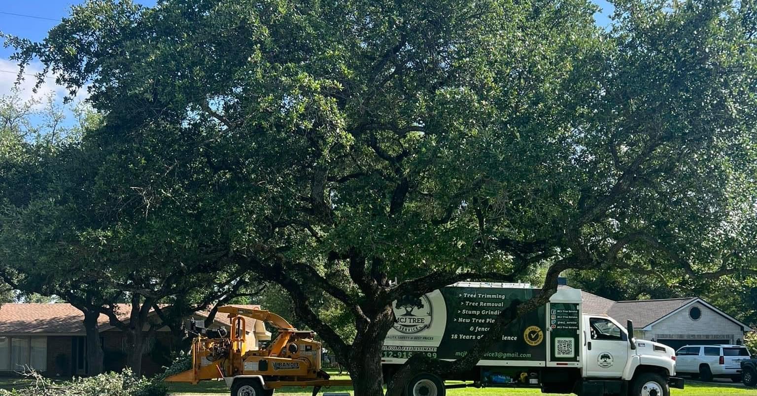 MCJ Tree Service branded truck and wood chipper